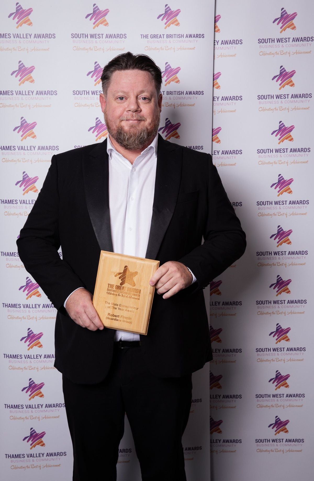 Rob Firmin holding his Male Entrepreneur of the Year award at the Great British Business Awards